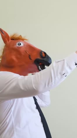 a man in a horse mask dances looking at the camera a man in a horse mask dances looking at the camera