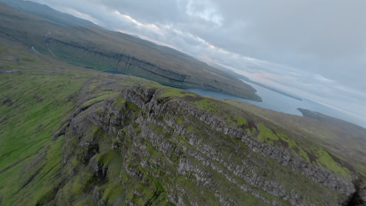 A breathtaking cliffside view in the Faroe Islands, with lush greenery and vast skies