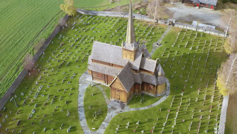 verdant landscape of graveyard with lom stave church in lom municipality, innlandet county, norway