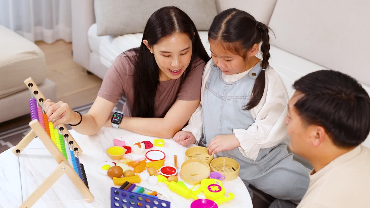 Parents and child interact with colorful educational toys in a bright, cozy living room setting