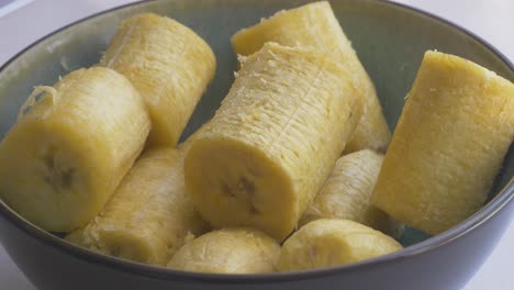 Putting-hot-banaba-plantain-in-a-bowl-to-be-mashed