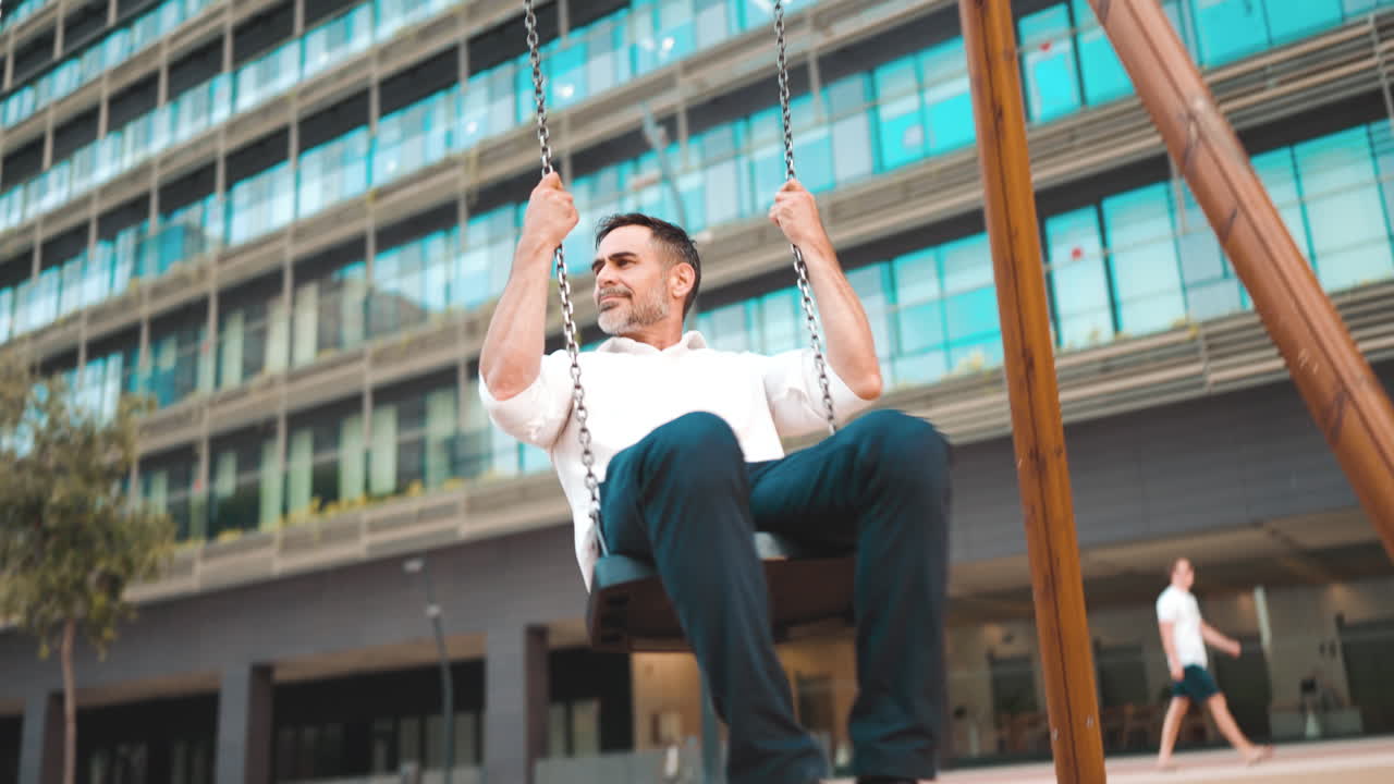 Businessman swinging in front of office building
