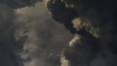 dark, thick cumulonimbus clouds moving across the sky, point of view