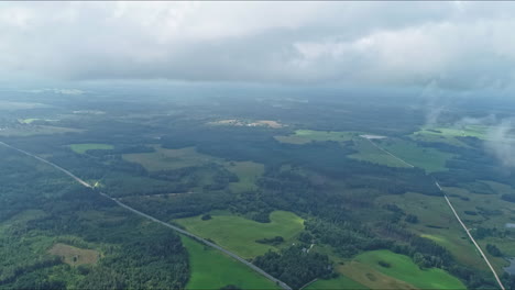 High-aerial-panoramic-view-among-the-clouds-on-a-green-landscape