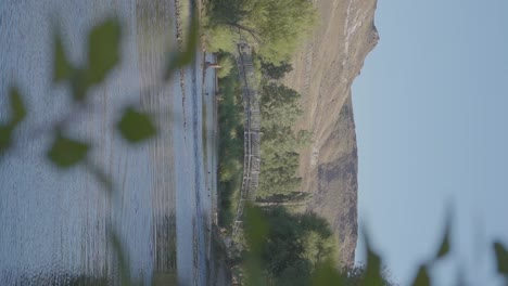 Green hills and a bridge over the river in Patagonia, Argentina