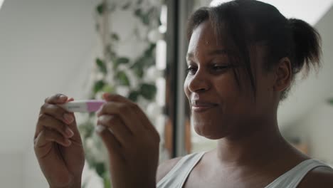 close up of african-american stressed woman  waiting for pregnancy test results.