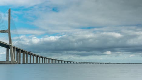 timelapse of the vasco da gama bridge in lisbon, portugal on a cloudy day