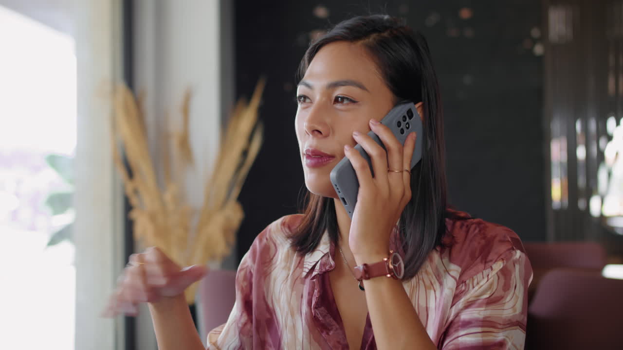 Female Entrepreneur Having Call when Drinking Coffee in Cafe