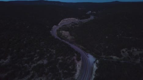 a stretch of highway in the new mexican mountains in the evening