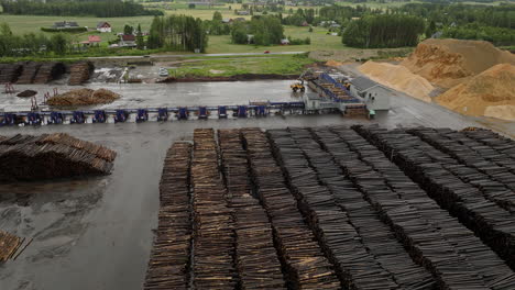 drone flyover huge log pile in forestry company yard