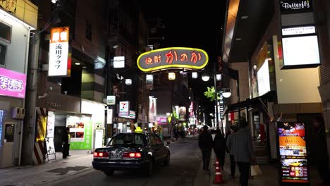 pedestrians and taxis on a lively urban night.