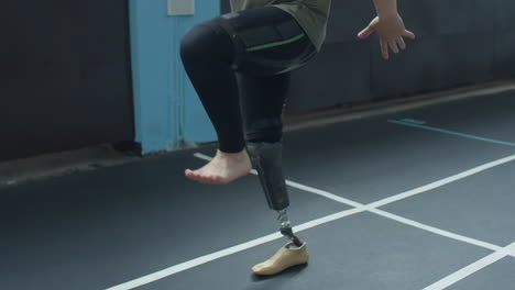man with prosthetic leg doing high knee walk