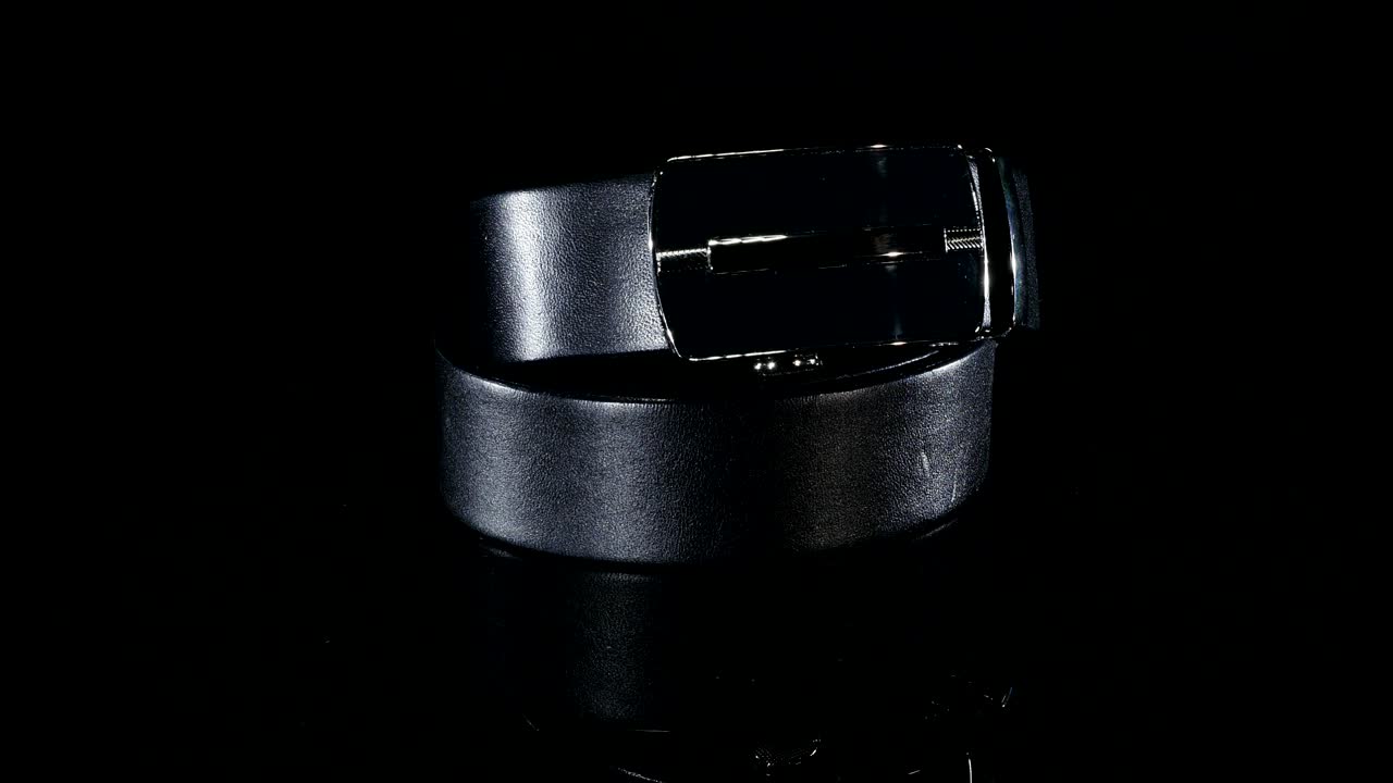 Black men's belt rotate on a black background