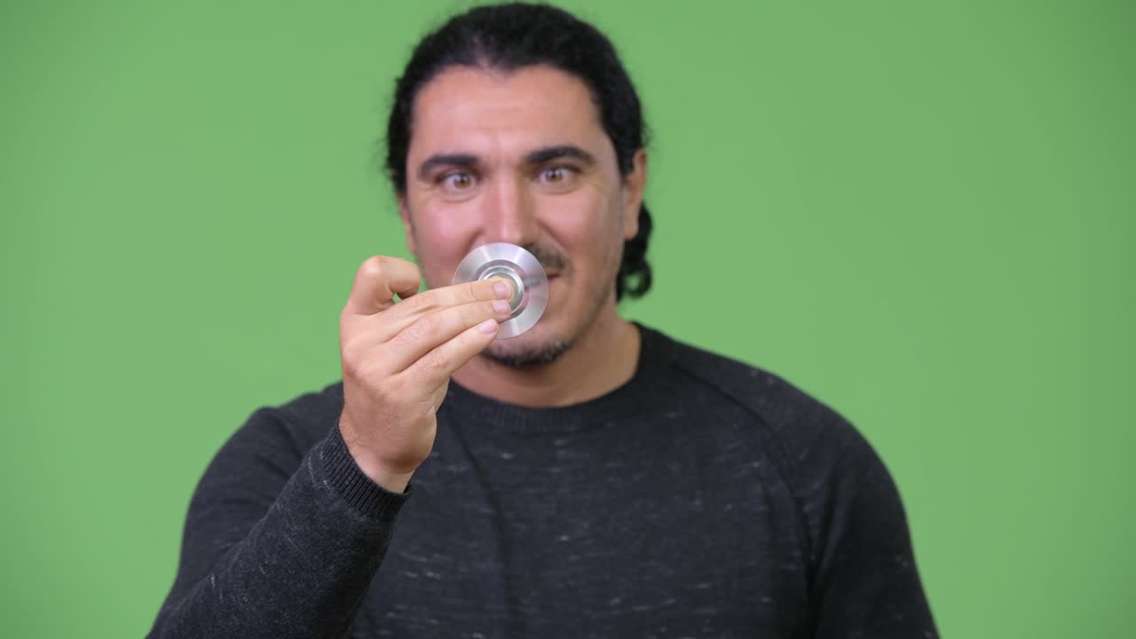 Handsome man playing with fidget spinner