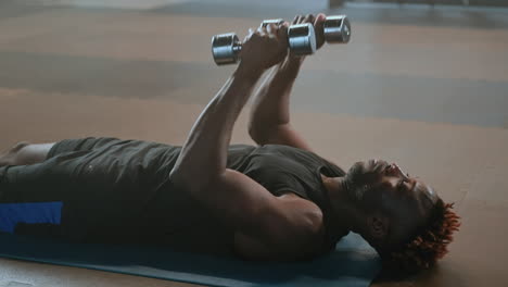 man performing dumbbell exercises