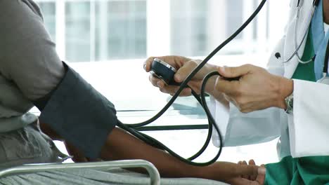 a doctor checking a patients blood pressure