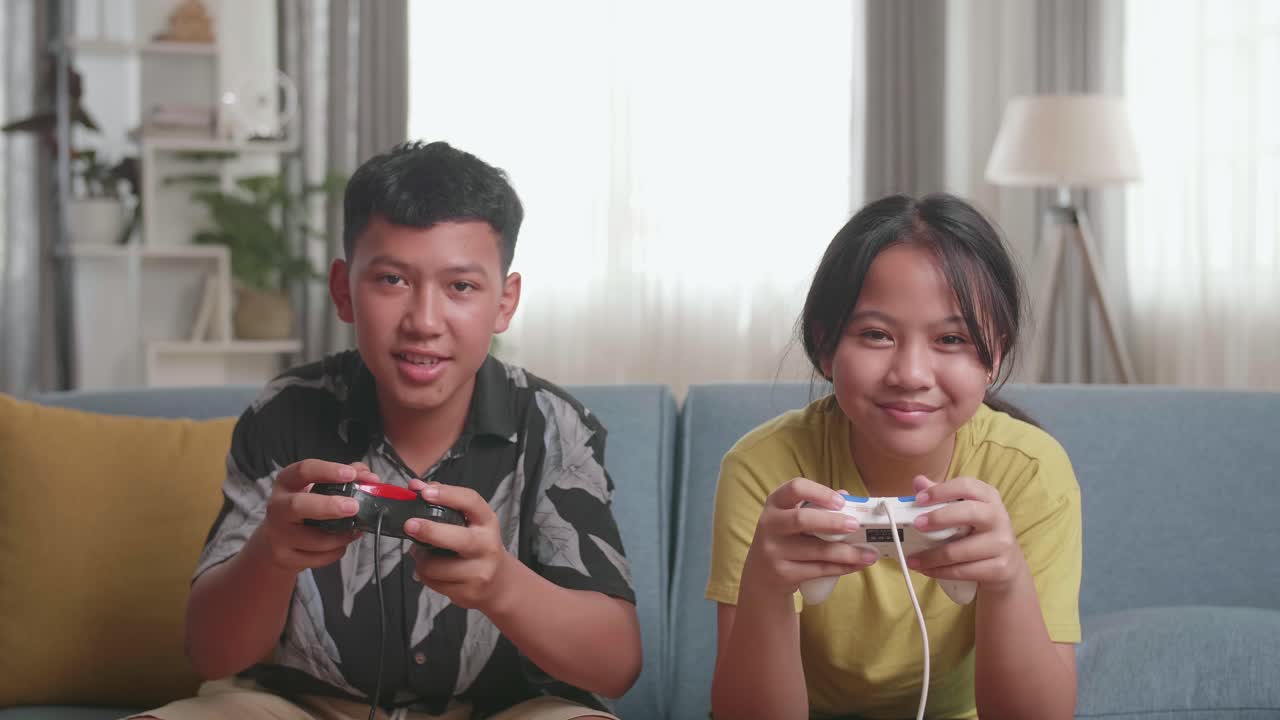 Asian Children With Joystick Game Play Video Game On Tv And Celebrating Victory