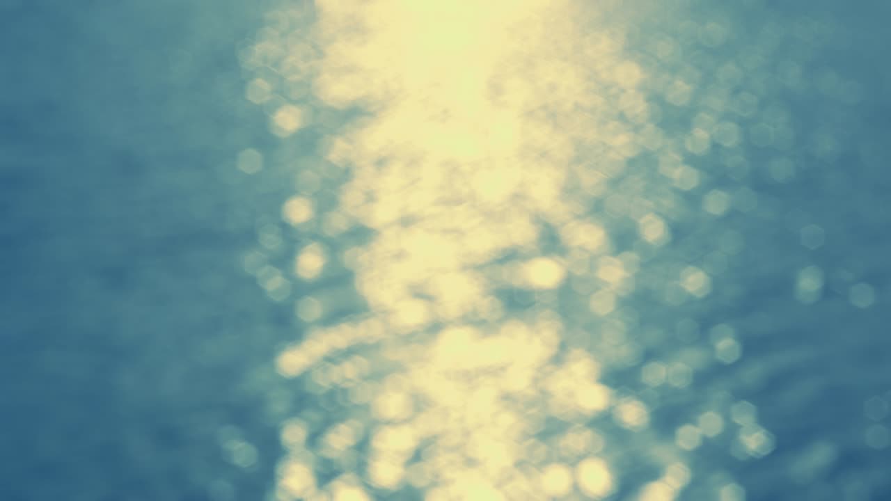 By the Water - Seamless loop of a completely defocused 4k-shot of a beautiful rippling and sparkling water surface