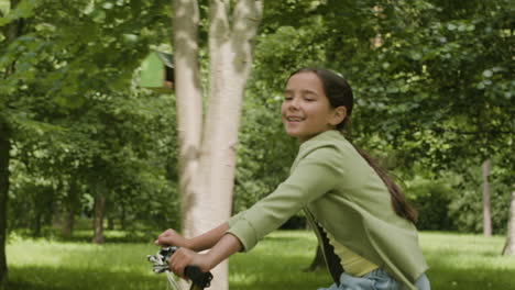 girl riding a bike in the park