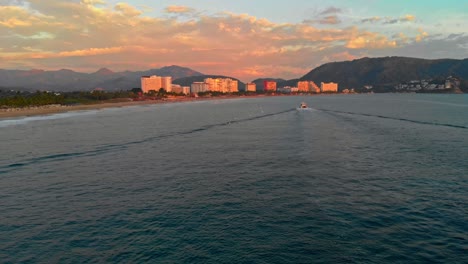 drone : following shot of a boat at sunset in ixtapa zihuatanejo