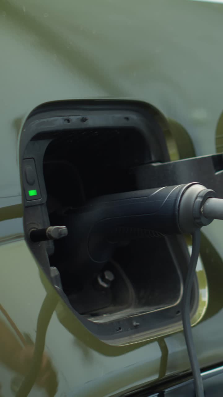 Vertical video Driver closing battery charging port flap of electric car after recharge