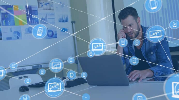 Uomo d'affari che lavora al laptop, utilizzando un'animazione di rete digitale in ufficio