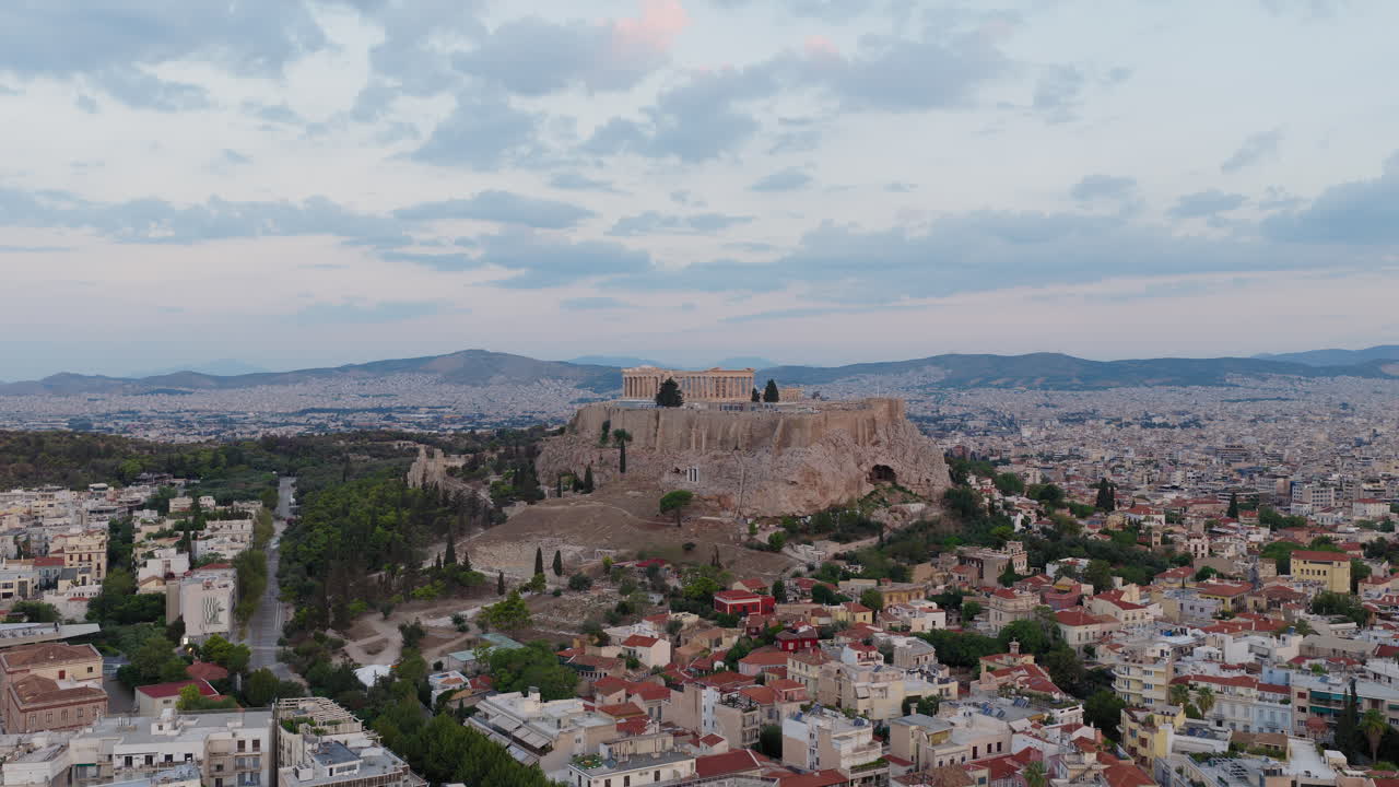 Acropolis and Parthenon at sunrise, Athens cityscape in background, aerial dolly establish