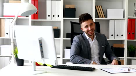 businessman in workplace rejoicing and spinning on chair