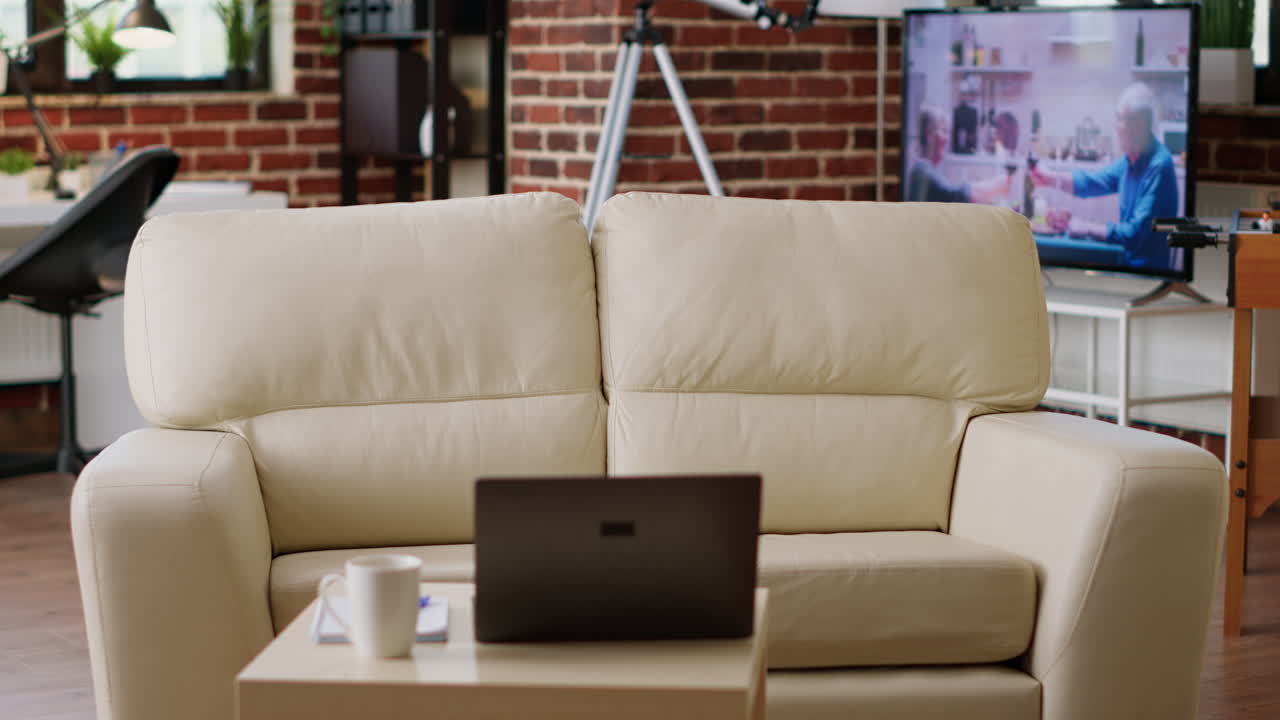 Living room with sofa, laptop, and TV