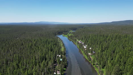 Wide-Still-Clear-Water-River-Near-Small-Forest-Town-[4K