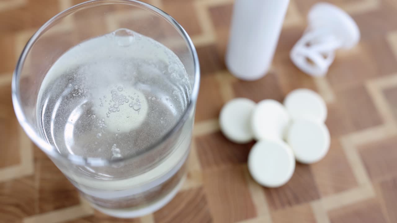 Effervescent tablet dissolving in a glass of water