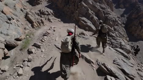 soldiers hiking in a mountainous terrain