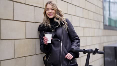 woman with coffee and electric scooter