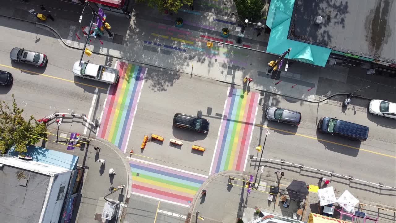 super slow aerial twist over gay pride LGBTQ downtown community with 4 painted road flags describing sexuality of the village davie and bute vancouver canada 1-2