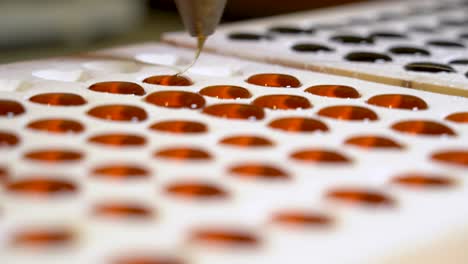 pouring the syrup into the powdered sugar molds when making typical dutch sweets