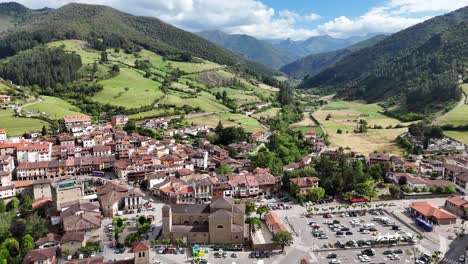 Aerial View of a Traditional Town in a Green Mountain Valley