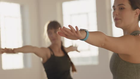 yoga class instructor teaching pregnant women exercising healthy lifestyle practice warrior pose enjoying group physical fitness workout in studio at sunrise