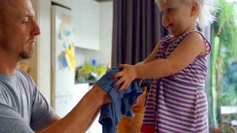 father wiping his daughters hands with napkin 4k