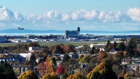 yvr station and control tower at vancouver international airport with aircraft landing