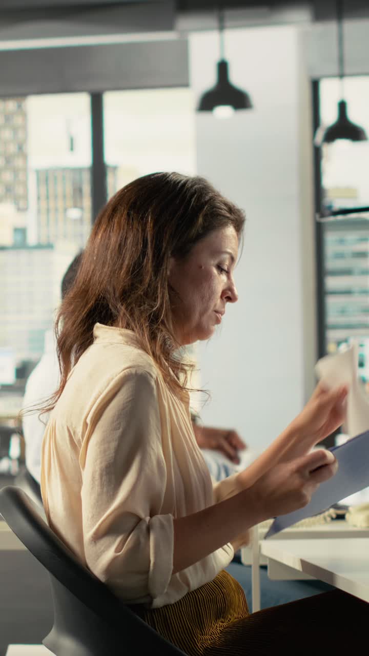 Vertical Video Business staff in modern office sharing insights and reports with colleagues