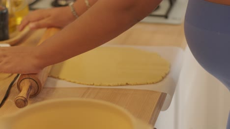 a pregnant woman enjoying her daily routine at home, relaxing in the living room and eating in the kitchen. the scene highlights comfort, maternity, and moments of self-care in a cozy setting