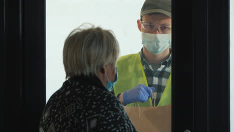 Delivery-Man-Brings-Food-Bags-To-Elderly-Woman's-Home