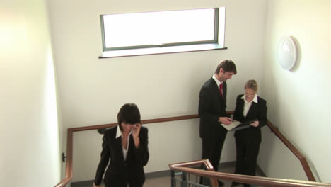 Business-People-Talking-on-Stairwell