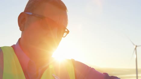 engineer writing on clipboard in the wind farm 4k