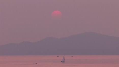 sailboat moving through smoke. smoke filled sky