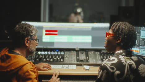 music producer and sound engineer collaborating in control room