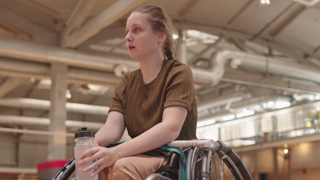 Girl with Disability Drinking Water in Gym