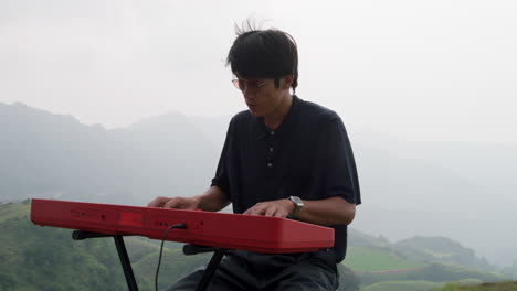 musical artist playing his keyboard player outdoors