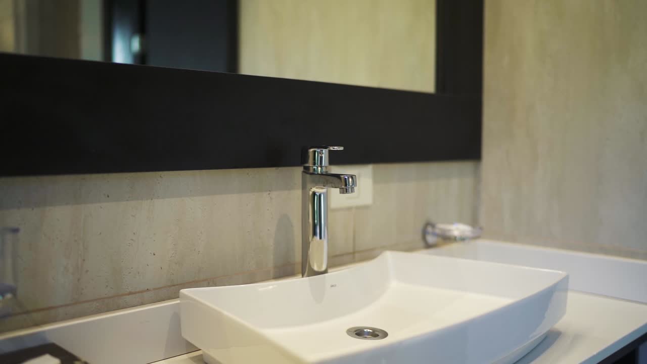 Modern bathroom sink and mirror in a clean and minimalistic interior design, Patagonia, Argentina.