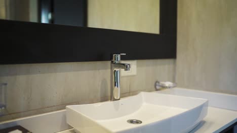 Modern bathroom sink and mirror in a clean and minimalistic interior design, Patagonia, Argentina.